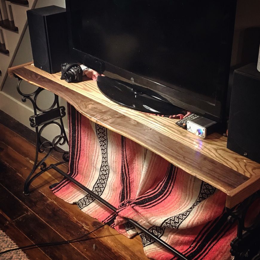 live edge walnut & oak console table with tv. homemade, diy, with cast iron legs from a sewing machine